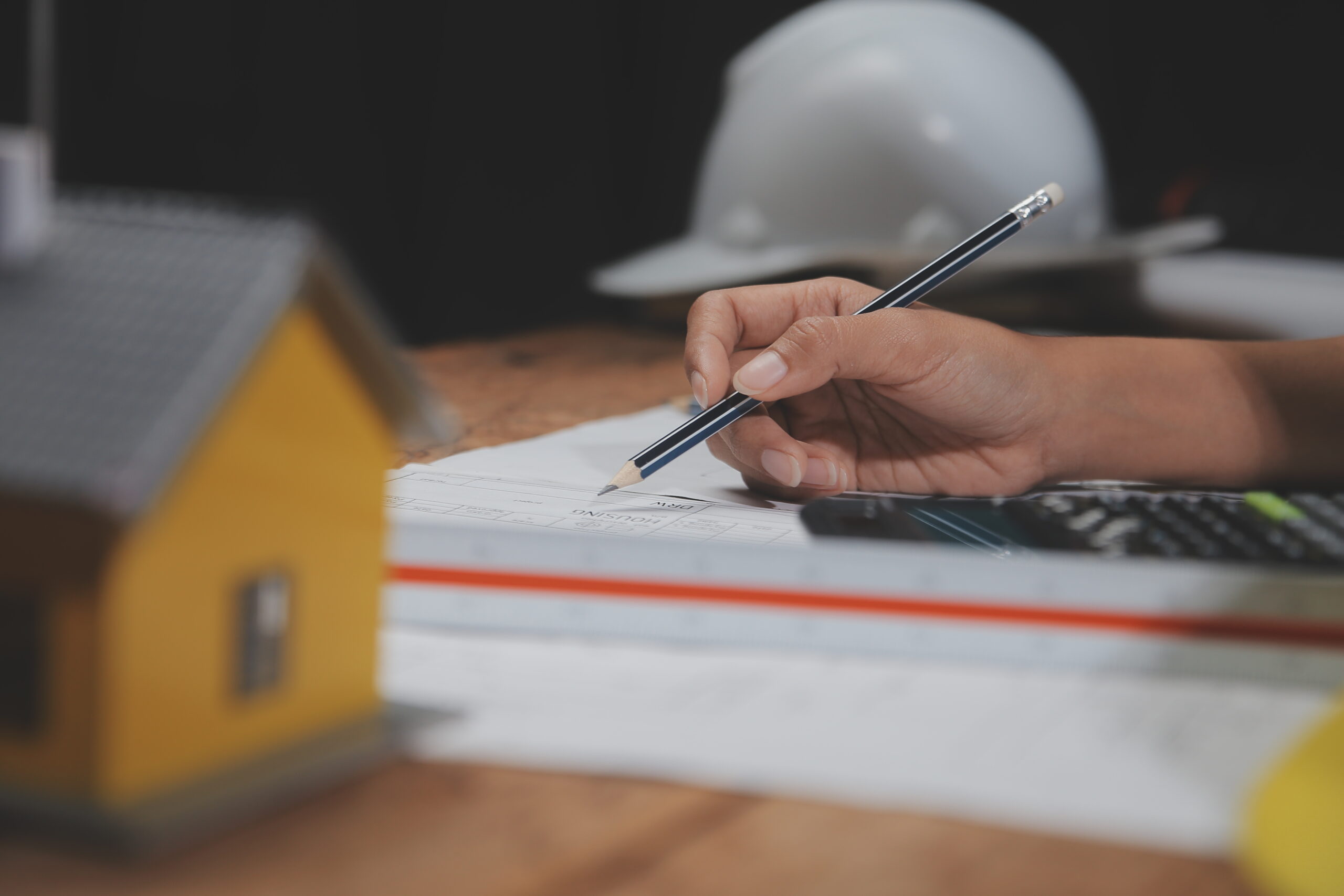 Home team of multiethnic architects working on construction plans in